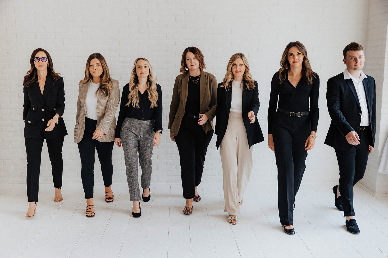 Professional recruiting team walking confidently in a modern office setting